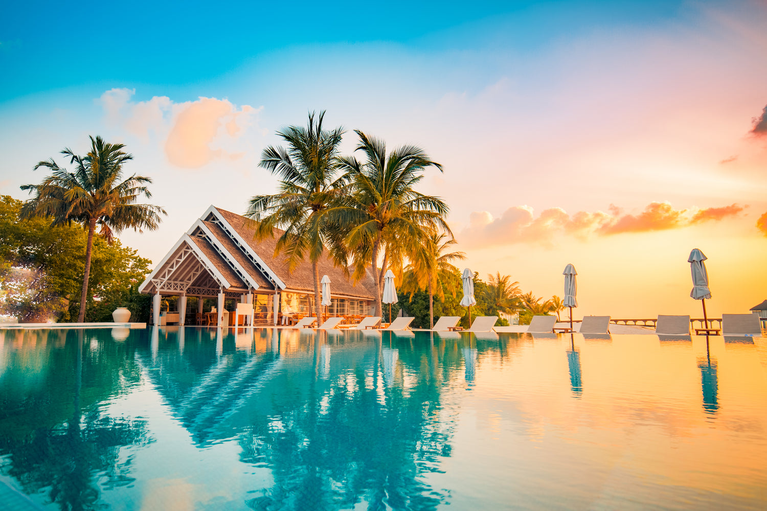 Tropical villa at sunset with pool