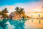 Tropical villa at sunset with pool