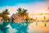 Tropical villa at sunset with pool