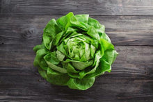 Head of lettuce on table